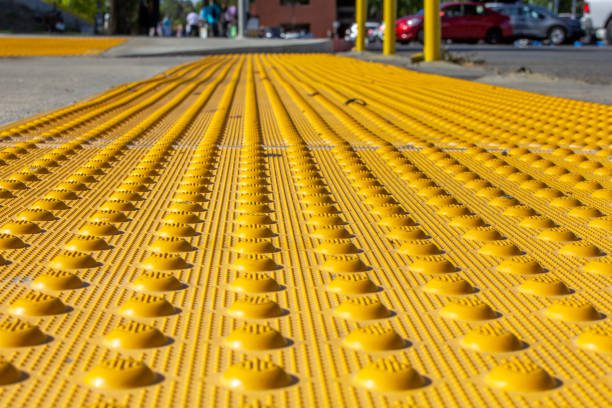 A yellow plastic walkway with bumps on it.