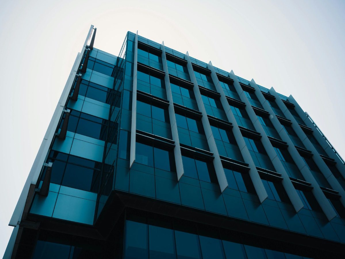 A tall building with many windows and some steps