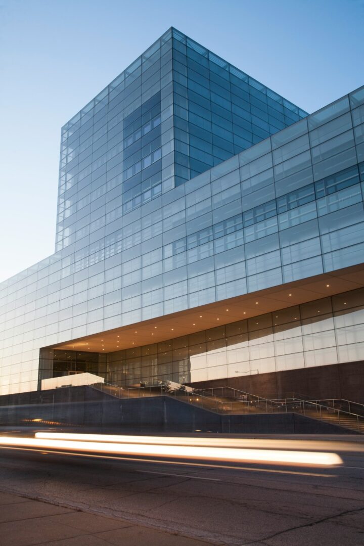 A building with many windows and glass on the outside.